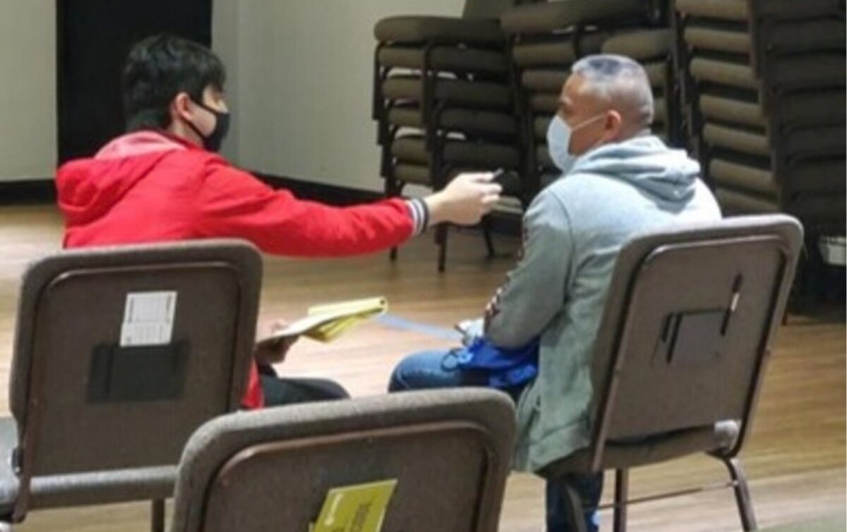 A Camino researcher conducting a research interview with a community member