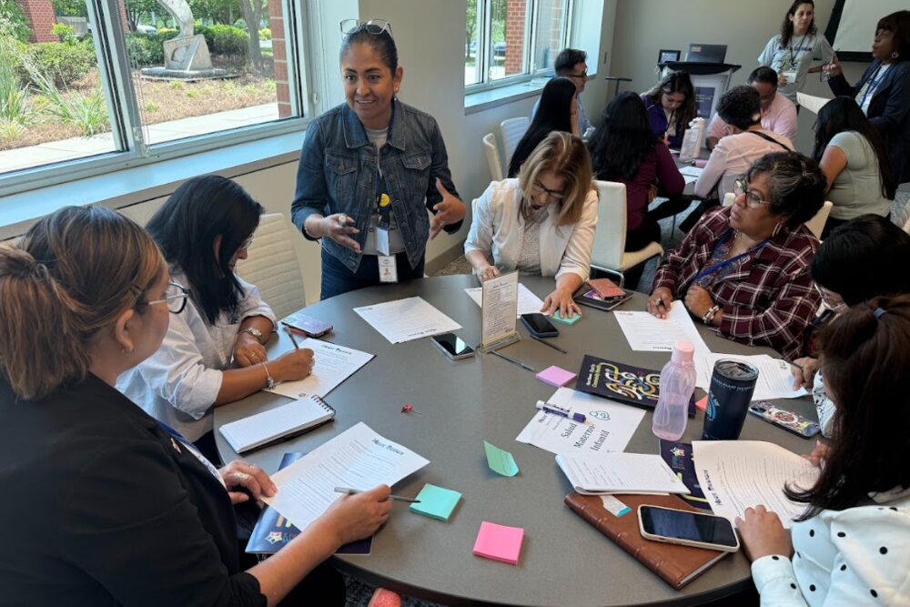 Community leaders and staff working together around a table at a roundtable meeting